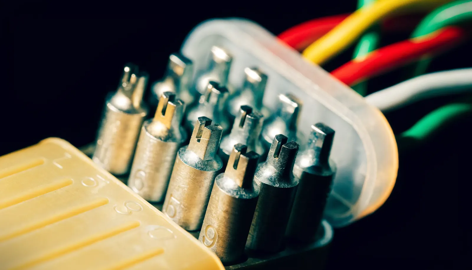 A multi-pin trailer connector opened up, showing the pin terminals and coloured wires